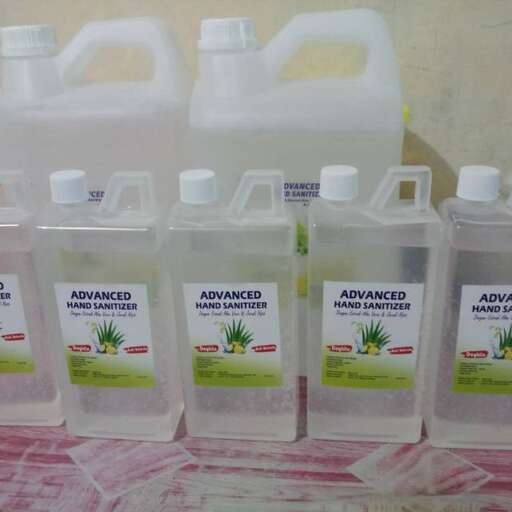 a bunch of bottles of juice sitting on a table.