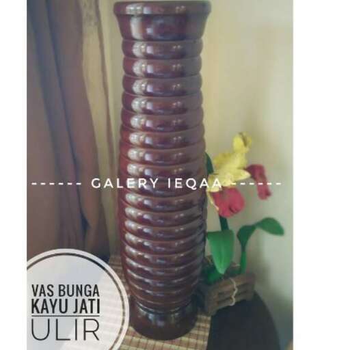 a tall vase with flowers in it.