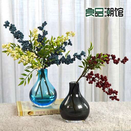 a vase with flowers on a table