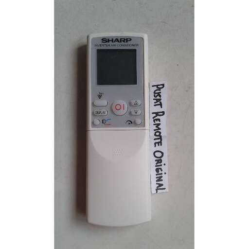 a white remote control sitting on a table.