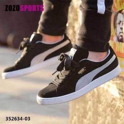 a pair of black and white sneakers with a white stripe.