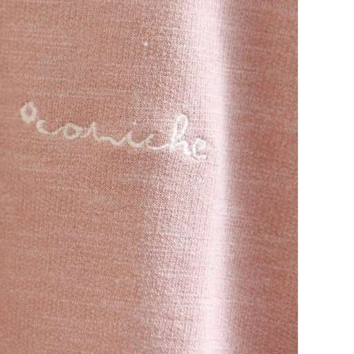 the white stitching on the fabric is a soft pink color.