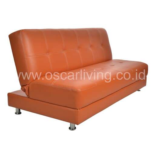 the orange leather sofa is a very comfortable chair.