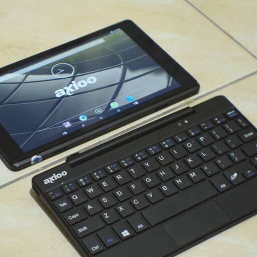 a tablet and tablet sitting on a table.