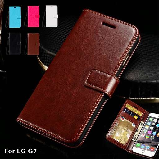 a brown leather wallet with a cell phone next to it.