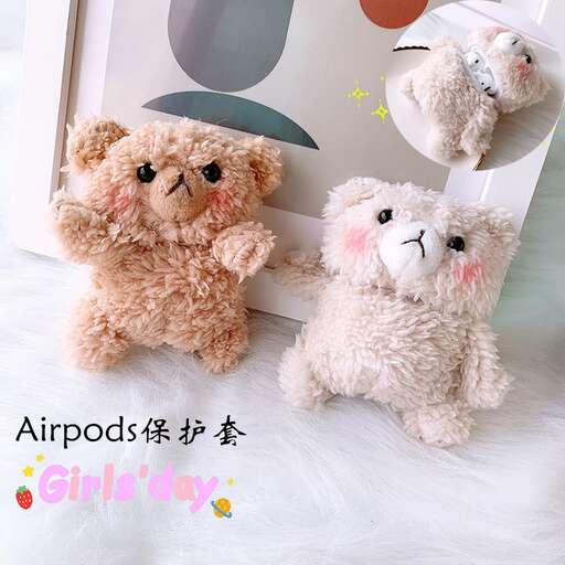 a stuffed animal sitting next to a picture of a teddy bear.