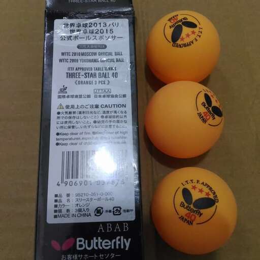 three oranges and a box of fruit.