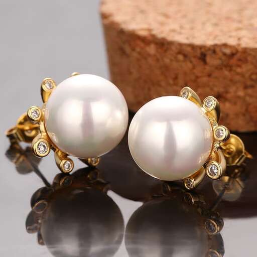 a pair of 18k gold plated pearl and diamond earrings