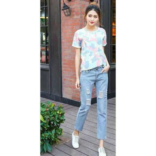 a printed t - shirt is worn with a pair of jeans and a white sneakers.