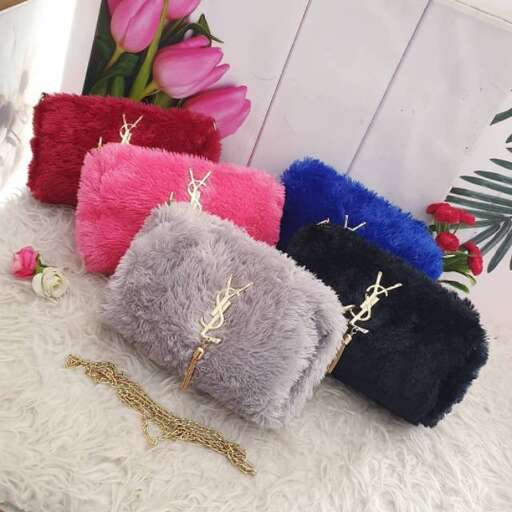 a bunch of different colored pillows and some pink flowers