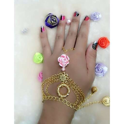 a bracelet with a flower design on the middle finger.