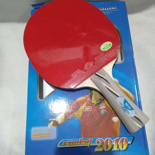 a red ping pong paddle and a ping pong paddle