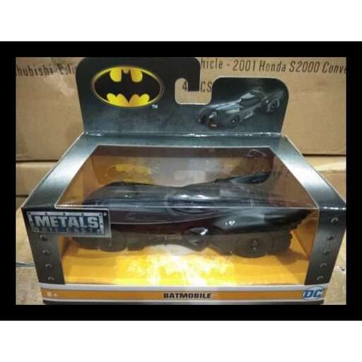 a toy car inside a box with a batman logo on it.