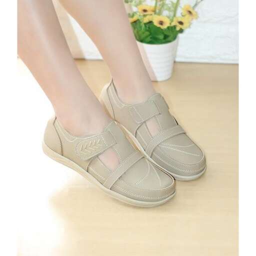 a woman's feet in beige sandal.