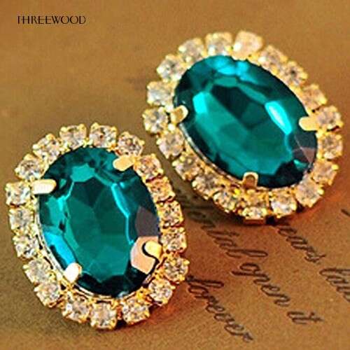 a pair of emerald and diamond earrings