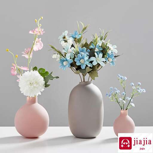 three vases with flowers in them are sitting on a table.