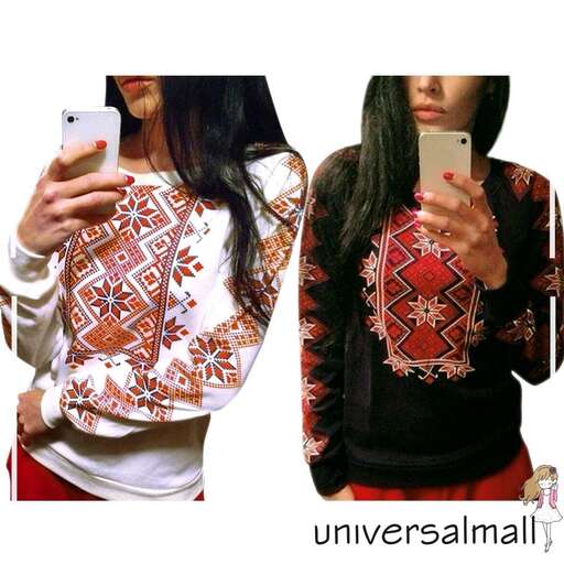 a black and white sweater with a red floral design.