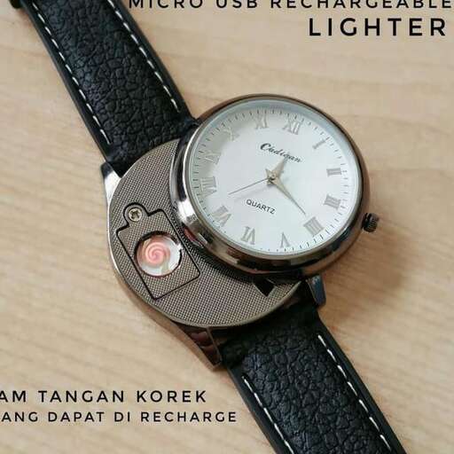 a watch with a black strap on a wooden table.