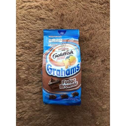 a bag of chips that is on a brown background.