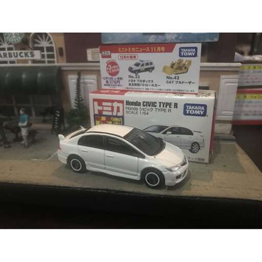 a toy car with a car in the background.