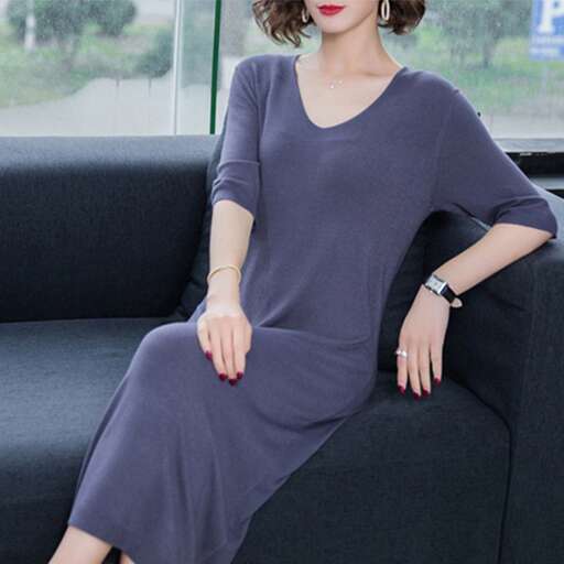 person is a long sleeved dress with a long neckline and a short skirt.