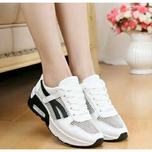 a woman's feet in sneakers.