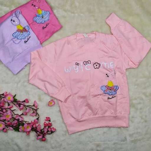 pink shirt with a cute little bird in the middle