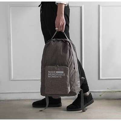 a man holding a bag with a bag in his hand.