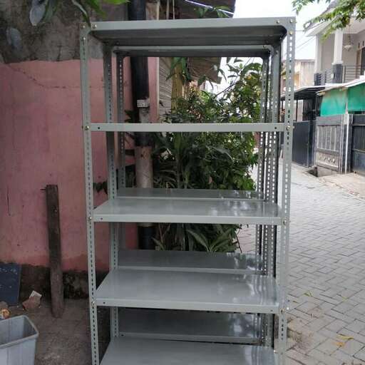 a metal shelf is sitting on the ground.