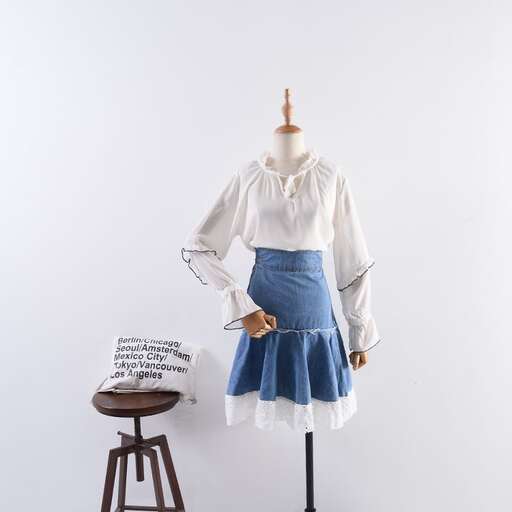 a mannequin with a white blouse and a sign on it.