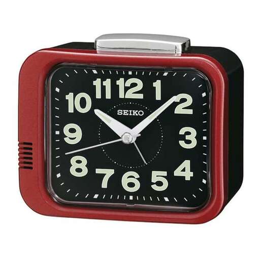 a red clock with a white face and black dial.