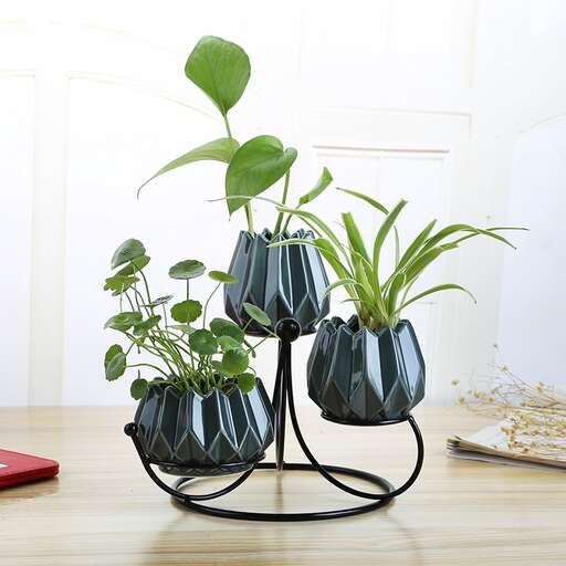 a table with a planter and a book on it