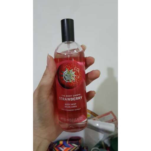 a hand holding a bottle of soap