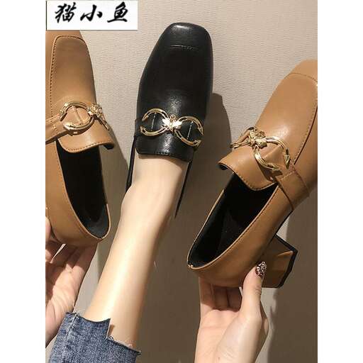 a pair of black leather shoes with gold embroidery