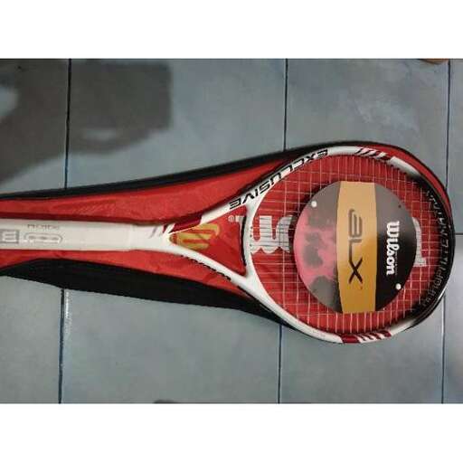 a tennis racket is laying on the floor.