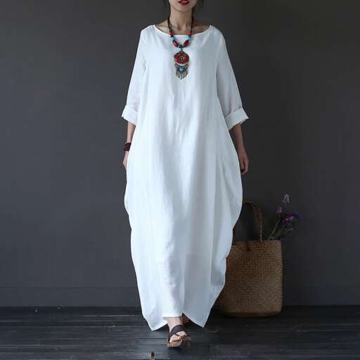 white dress with a colorful necklace