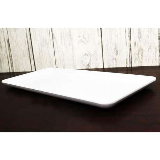 a white laptop computer sitting on a table.