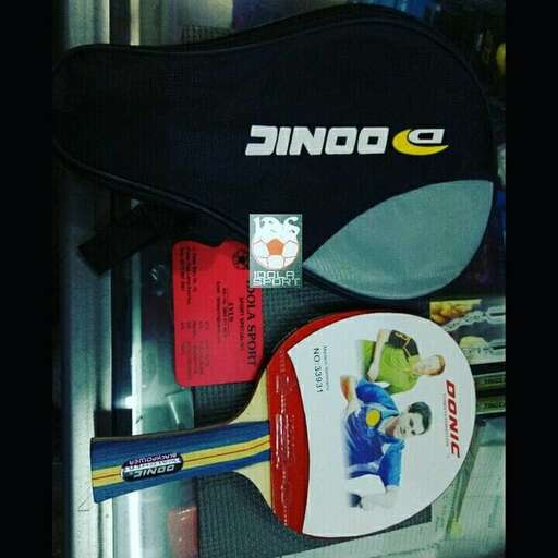 a black and white bag sitting on top of a shelf.