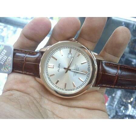 a watch with a leather strap on it.