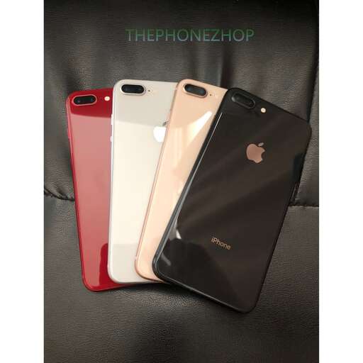 a couple of red and white iphones sitting on a black surface.