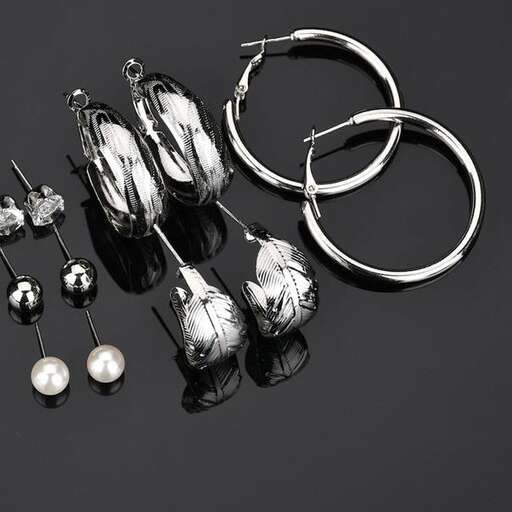 a pair of earrings and earrings are on a black background.