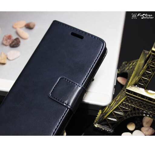 a cell phone sitting on a table next to a case.