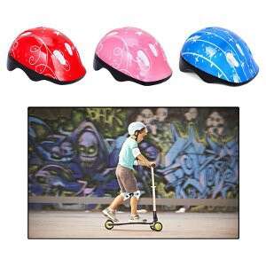 a boy riding a scooter with a helmet on.