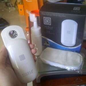 a person holding a bottle of liquid in their hand.