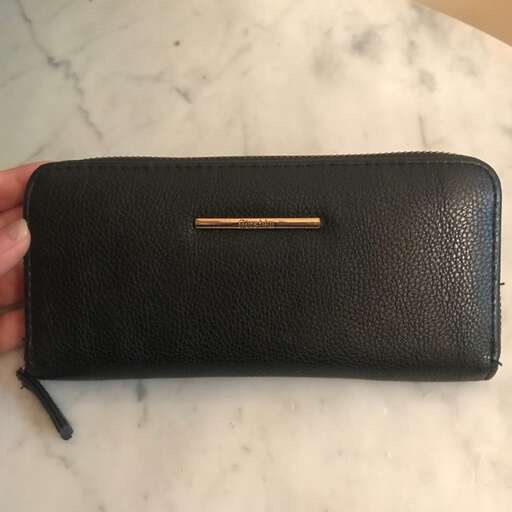 a small leather wallet with a zipper on the front.