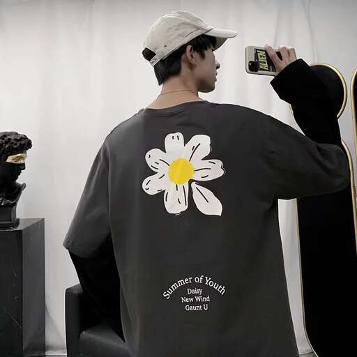 a man in a hat is taking a picture of a flower.