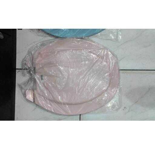 a large pink turkey wrapped in plastic.