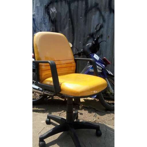 a yellow chair with a black seat and a blue motorcycle in the background.