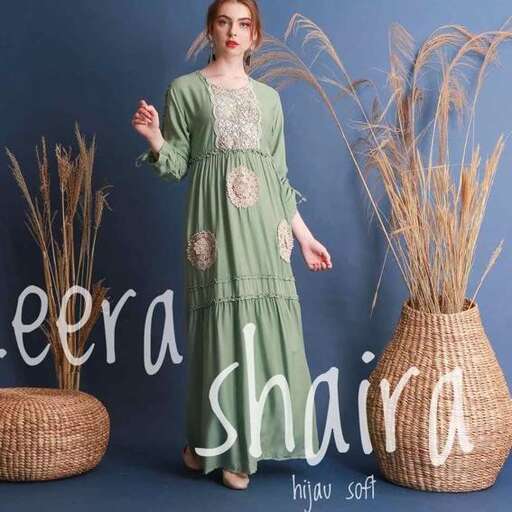 a woman in a green dress and straw baskets