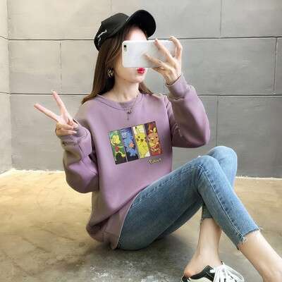 a girl with a paper heart on her face is holding up a paper sign.